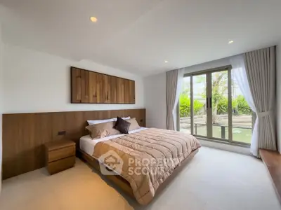 Spacious bedroom with large window and modern decor