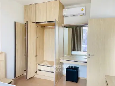 Modern bedroom with built-in wardrobe and air conditioning unit