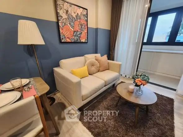 Charming living room with cozy seating and stylish decor, perfect for relaxation and entertaining.
