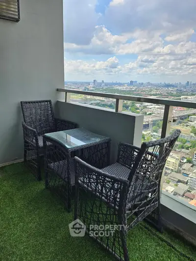 Stunning balcony with city view and stylish outdoor seating on artificial grass.
