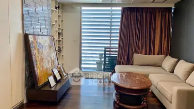 Spacious living room with modern decor and large window for natural light