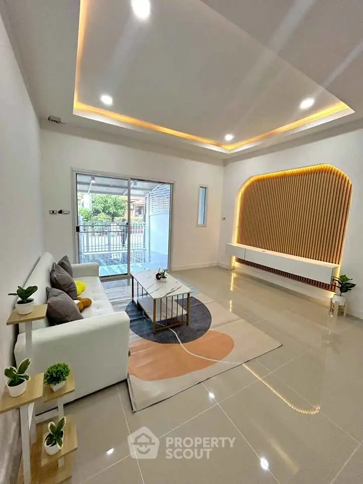 Modern living room with stylish ceiling lights and cozy seating area.
