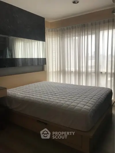 Modern bedroom with large windows and elegant decor