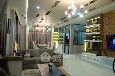 Luxurious modern living room with elegant lighting and spacious seating area.