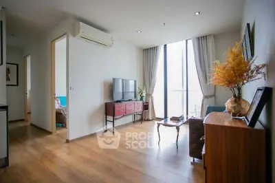 Spacious living room with wooden flooring and large windows in modern apartment