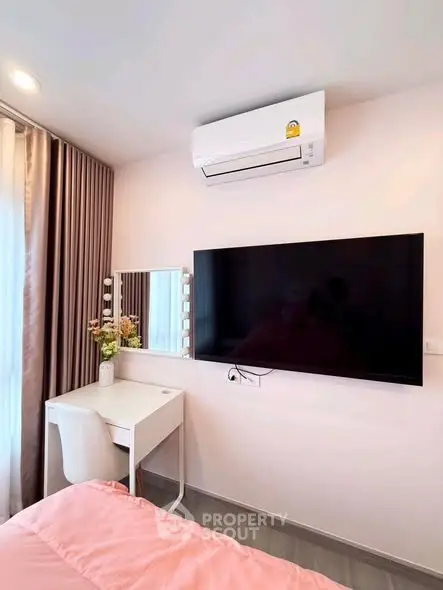 Modern bedroom with wall-mounted TV and stylish vanity setup