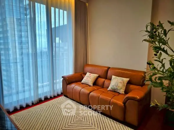 Cozy living room with leather sofa and large window view