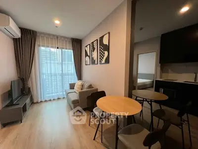 Modern living room with cozy seating and stylish decor in open layout apartment.