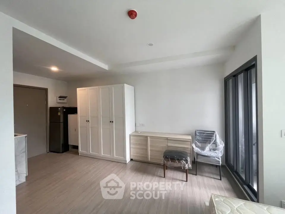 Spacious modern living room with sleek furniture and large windows for natural light.