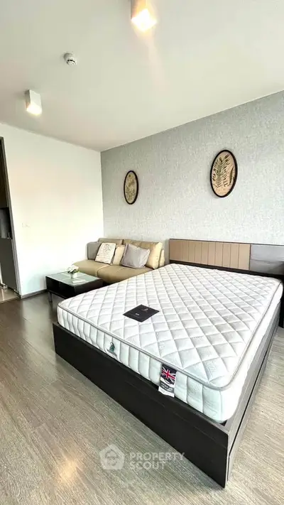 Modern bedroom with stylish decor and comfortable mattress in a cozy apartment.