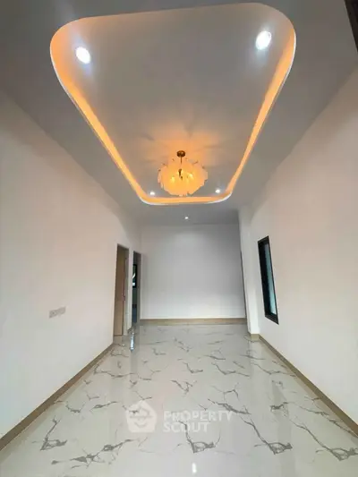Elegant modern interior with stylish ceiling lighting and marble flooring, perfect for contemporary living.
