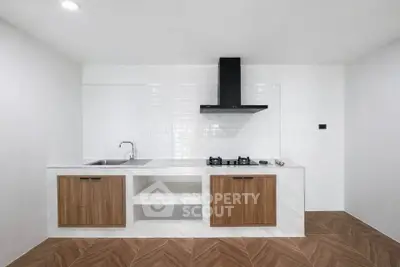 Modern minimalist kitchen with sleek cabinetry and gas stove