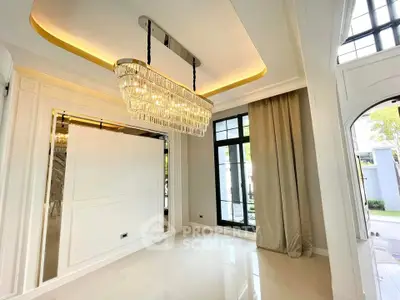 Luxurious interior with elegant chandelier and large windows in modern home