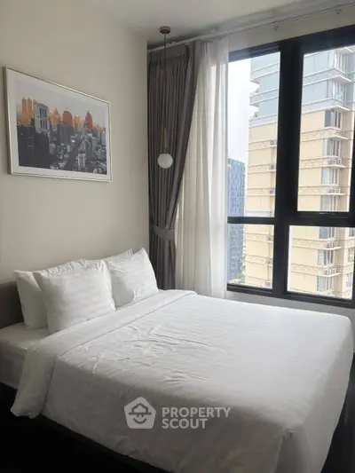 Modern bedroom with city view and stylish decor in high-rise apartment