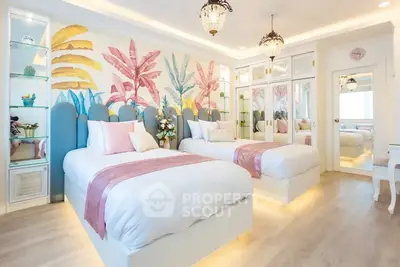 Charming twin bedroom with vibrant decor and mirrored wardrobes, perfect for a cozy and stylish living space.