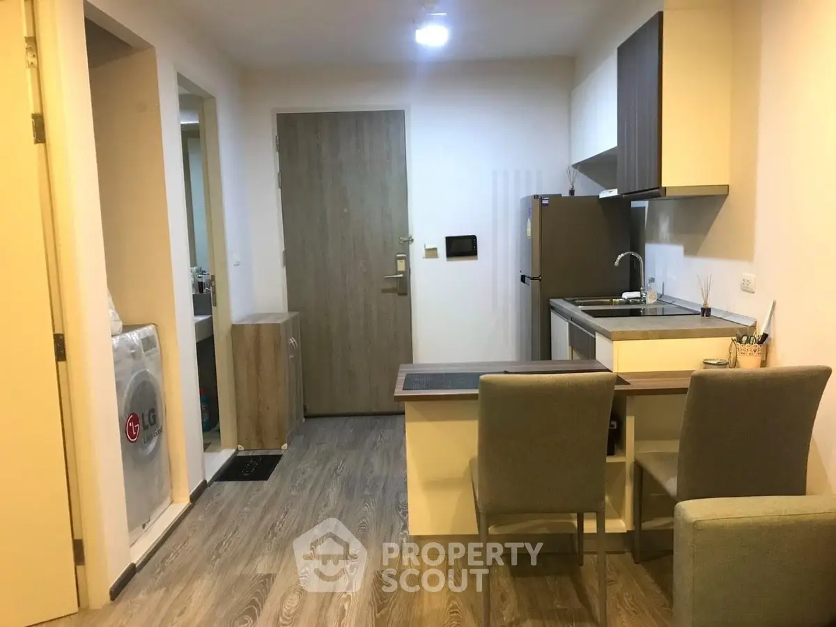 Modern compact kitchen with dining area in cozy apartment