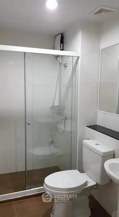 Modern bathroom with glass shower enclosure and sleek fixtures