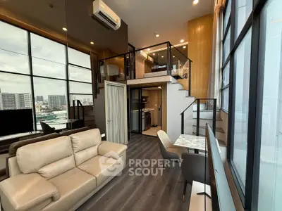 Luxurious loft apartment with modern interior, featuring a spacious living area and stunning city views.