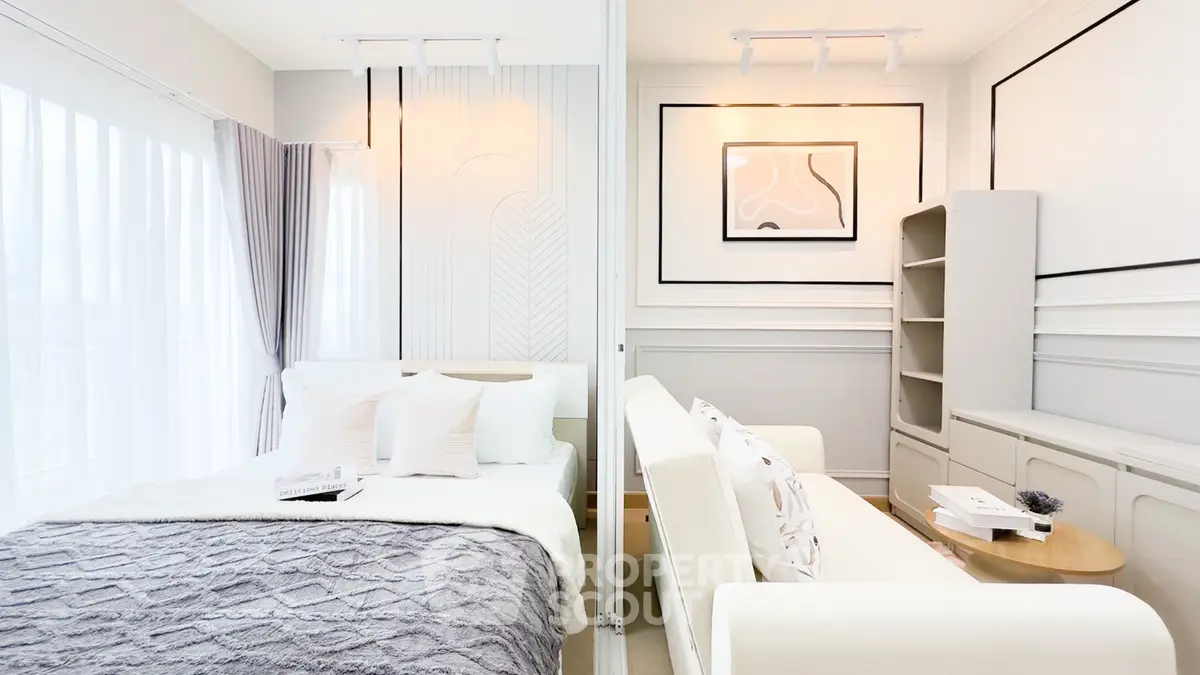 Luxurious modern bedroom with elegant decor and cozy seating area, perfect for relaxation and comfort.