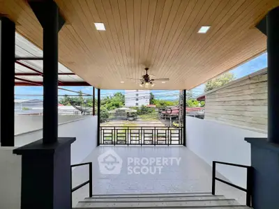 Spacious modern balcony with ceiling fan and scenic view, perfect for relaxation and entertainment.