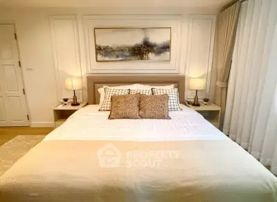 Elegant bedroom with cozy bedding and stylish decor in a modern apartment.
