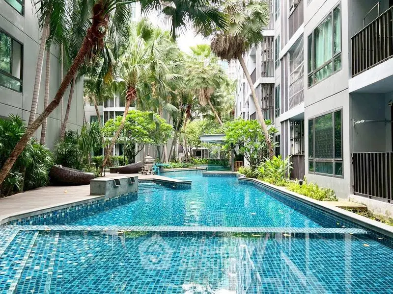 Luxurious condominium with stunning pool and lush greenery, perfect for relaxation and leisure.