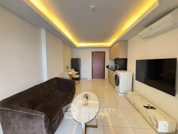 Modern living room with sleek furniture and integrated kitchen appliances