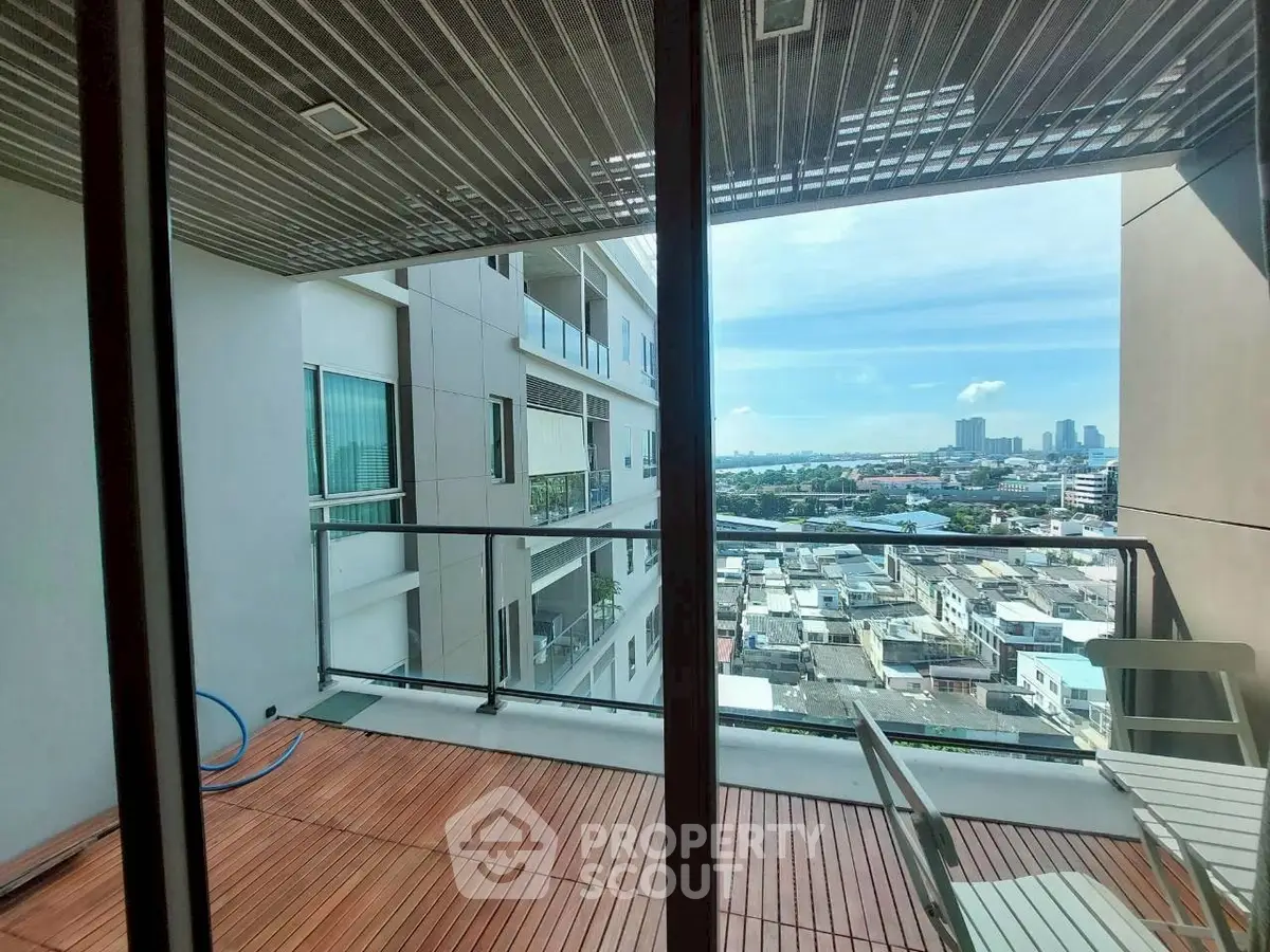 Spacious balcony with city view in modern apartment building