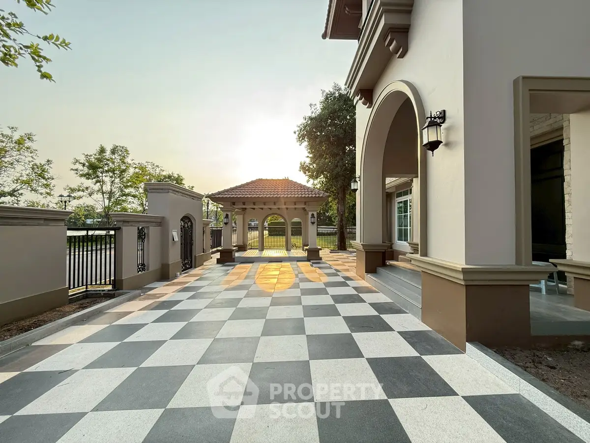 Elegant exterior with checkered patio and archway entrance, perfect for luxury living.