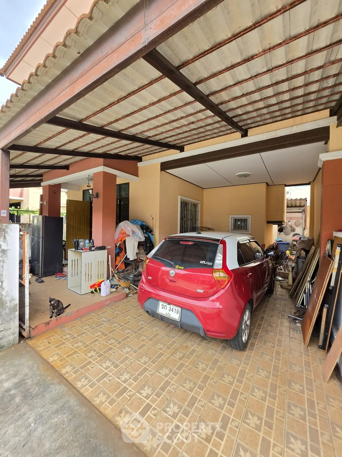 Spacious carport with tiled flooring and covered roof in suburban home