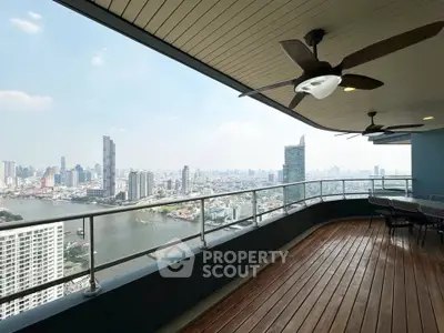 Stunning high-rise balcony with panoramic city and river views, perfect for relaxation and entertainment.