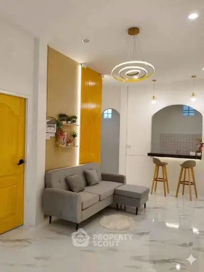 Stylish modern living room with elegant lighting and open kitchen layout