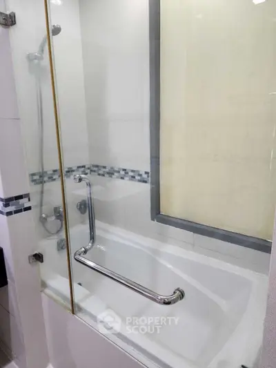 Modern bathroom with sleek bathtub and glass shower enclosure