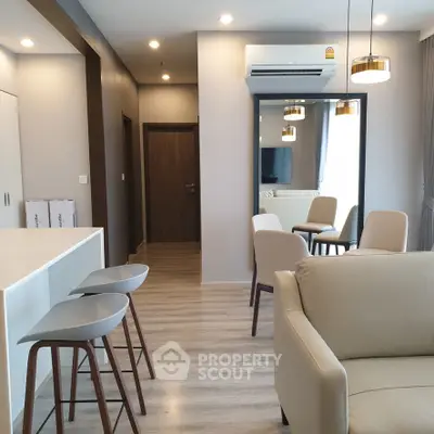 Modern open-plan living room with stylish furniture and air conditioning