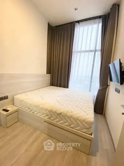 Modern bedroom with large window and sleek design