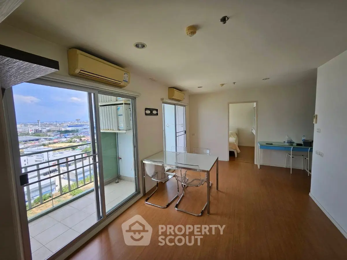 Spacious modern living room with balcony and city view