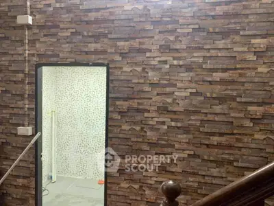 Stylish stone wall interior with modern bathroom entrance