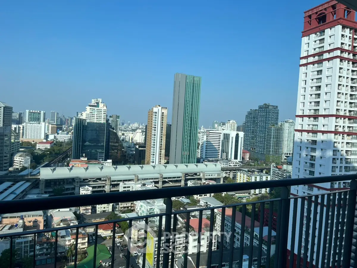 Stunning cityscape view from a high-rise balcony in urban setting.