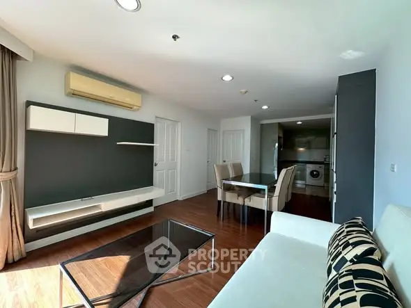 Spacious modern living room with dining area and open kitchen in a stylish apartment.