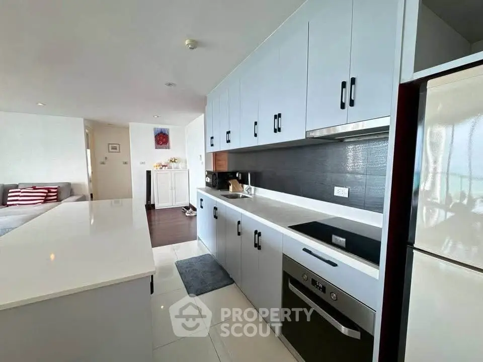 Modern kitchen with sleek cabinetry and integrated appliances in a stylish open-plan living space.
