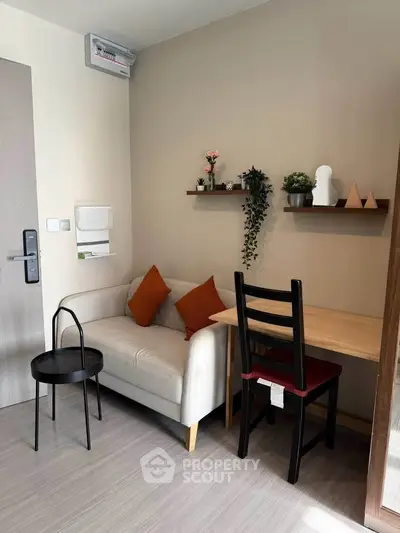 Cozy living room with modern decor and compact furniture, perfect for urban living.