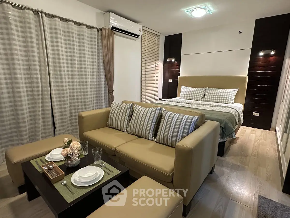 Modern studio apartment with cozy living area and stylish bedroom