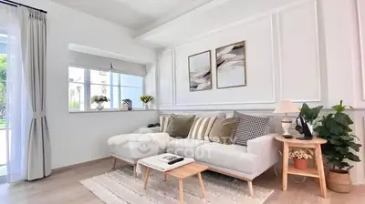 Bright and modern living room with stylish decor and large window view.