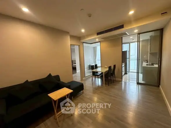 Modern living room with open kitchen and dining area in a stylish apartment