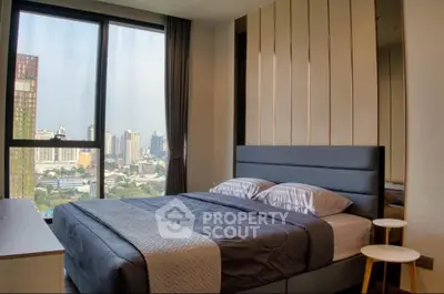 Modern bedroom with city view and stylish decor in high-rise apartment