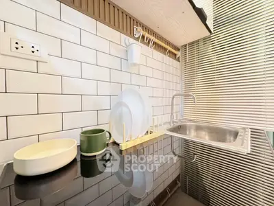 Modern kitchen with sleek black countertop and stylish backsplash