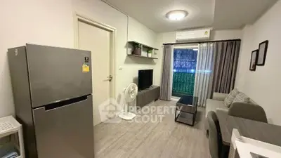 Modern living room with sleek furniture and large fridge, perfect for urban living.