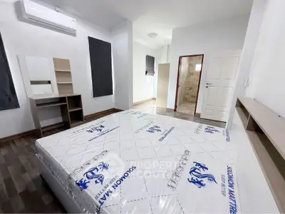 Spacious modern bedroom with new mattress and stylish furniture