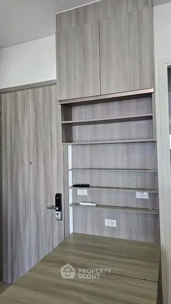 Modern interior with wooden shelves and door, showcasing minimalist design.