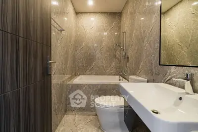 Luxurious modern bathroom with marble walls and sleek fixtures